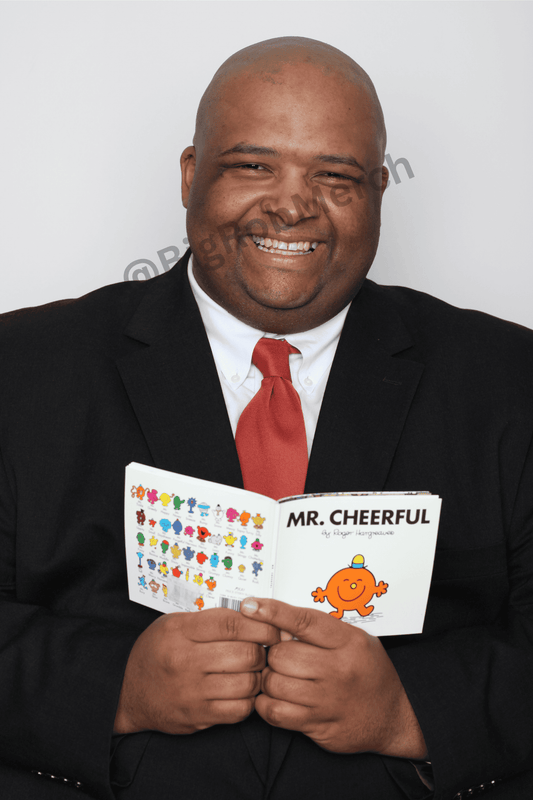 Autographed photo of Big Rob with Mr Cheerful book, smiling, looking at the camera